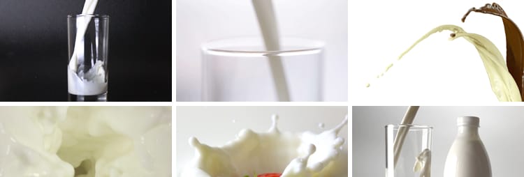 特写牛奶乳制品泼飞滴落溅起升高慢镜头摆拍鲜奶液体高清视频素材